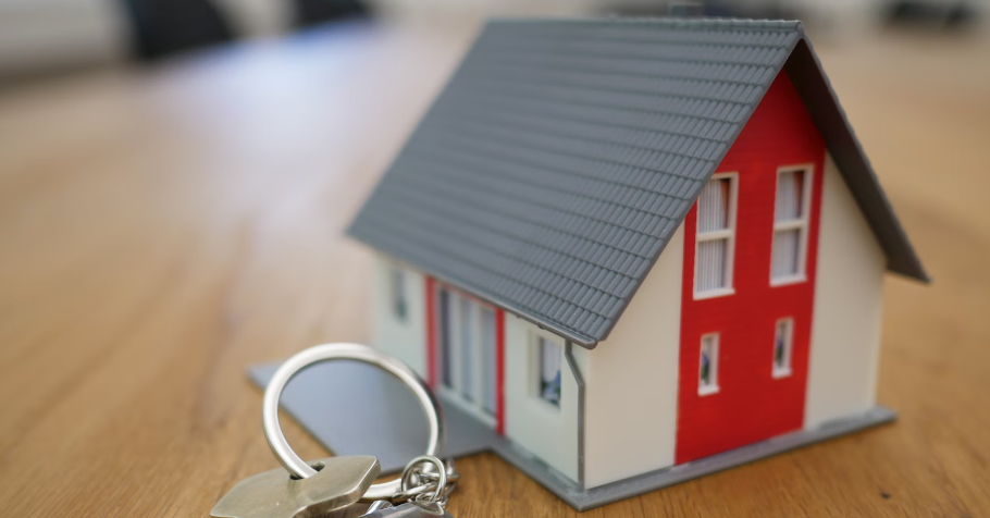 photo of a house with a set of keys in front